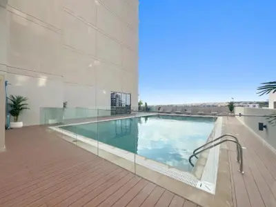 a large swimming pool in a building at Modern Studio close to Marina with Balcony - 5 min walk from Metro in Dubai