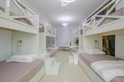 two beds in a room with white walls at Apartment in Downtown As Dormitory Room for female in Dubai