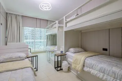 a bedroom with two beds and a window at Apartment in Downtown As Dormitory Room for female in Dubai