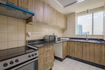 a kitchen with a sink and a microwave at Apartment in Downtown As Dormitory Room for female in Dubai