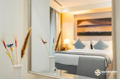 a bedroom with a bed and a mirror at Emmar fashion avenue Dubai mall in Dubai