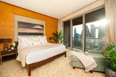 a bedroom with a bed and a large window at Emmar fashion avenue Dubai mall in Dubai