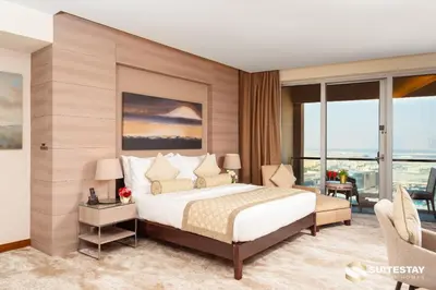 a bedroom with a large bed and a large window at Emmar fashion avenue Dubai mall in Dubai