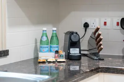 a counter with two bottles of water and a phone at Luxury 1BR Suite I Boulevard View I Downtown Dubai in Dubai