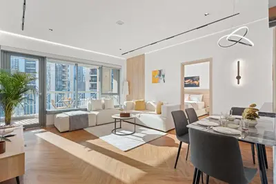 a living room with a white couch and a table at Luxury 1BR Suite I Boulevard View I Downtown Dubai in Dubai
