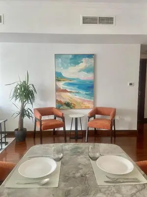 a dining room with a table and chairs and a painting at Sky High luxury Stay in Dubai Marina ,with Marina View, High Floor, Modern Design, Pool Access by Stay Vista! Up to 6 Guests in Dubai