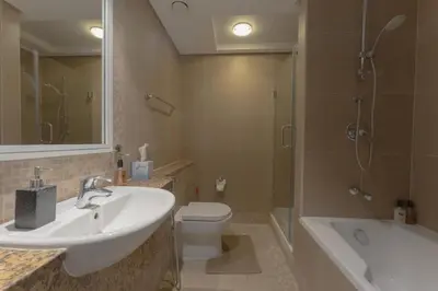 a bathroom with a sink and a toilet and a shower at Luxury 2BR Sky Gardens Appartment Downtown DIFC in Dubai