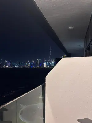 a view of a city at night from a building at Azizi Riviera 1 A in Dubai