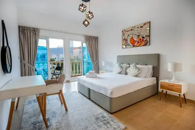 a bedroom with a bed and a table and a desk at Dubai Villa - Beautifully Appointed in Dubai