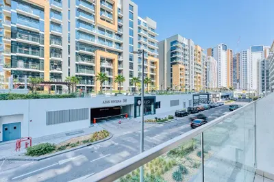 an empty street in a city with tall buildings at PVH - Cozy Studio in Azizi Riviera 43 in Dubai