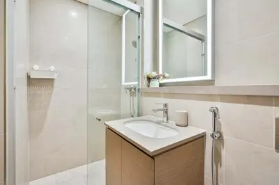 a bathroom with a sink and a mirror at PVH - Sobha Waves - Serene 1BR minutes to Downtown in Dubai