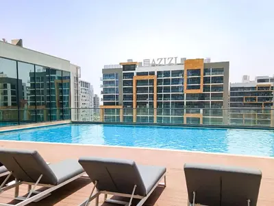 a large swimming pool on top of a building at PVH - Sobha Waves - Serene 1BR minutes to Downtown in Dubai