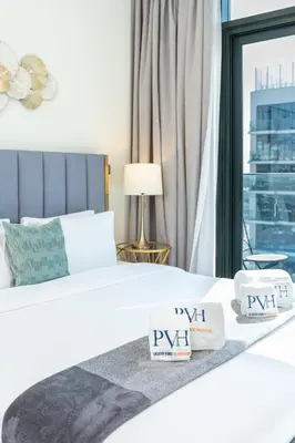 a hotel room with a bed and a window at PVH - Modern Studio Near Downtown - Azizi Riviera in Dubai