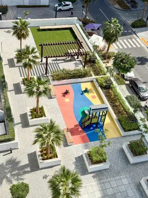 an aerial view of a pool with palm trees at PVH - Modern Studio Near Downtown - Azizi Riviera in Dubai