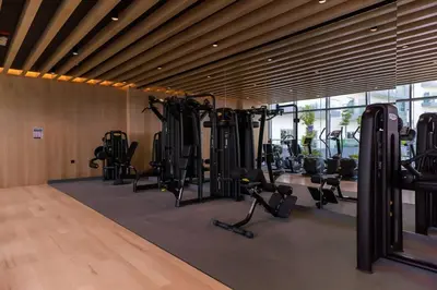 a gym with treadmills and exercise equipment in a room at PVH - Homely Studio near Miracle Garden in Dubai