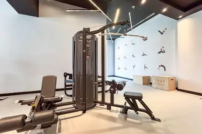 a gym with exercise equipment in a room at PVH - Sunny Studio near Metro - Madison Residency in Dubai