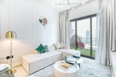 a white living room with a couch and a large window at PVH - Exquisite 1BR With Canal View - Binghatti Canal, Business Bay in Dubai