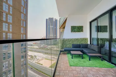 a balcony with a couch and a view of a city at PVH - Exquisite 1BR With Canal View - Binghatti Canal, Business Bay in Dubai