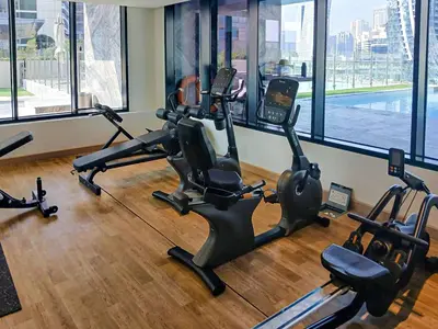a gym with treadmills and exercise bikes in a room at PVH - Exquisite 1BR With Canal View - Binghatti Canal, Business Bay in Dubai
