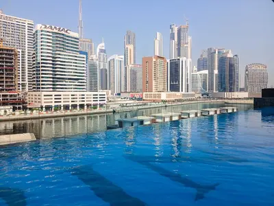 a river in front of a city with tall buildings at PVH - Exquisite 1BR With Canal View - Binghatti Canal, Business Bay in Dubai