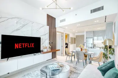 a living room with a television on a wall at PVH - Exquisite 1BR With Canal View - Binghatti Canal, Business Bay in Dubai