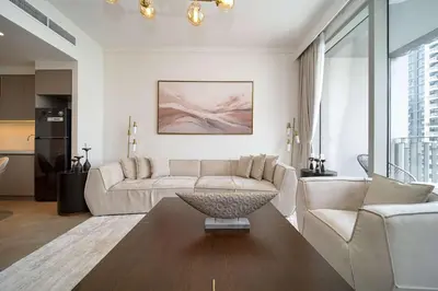 a living room with a couch and a table at PVH - Creek Gate - Stylish 2BR with Creek View in Dubai