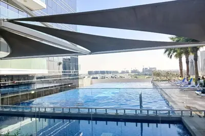 a swimming pool on the roof of a building at PVH - Classy Studio with Golf Course View - Carson in Dubai