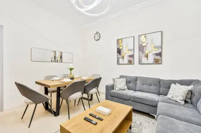 a living room with a couch and a table at PVH - 2BR near Marina Promenade - Marina Pearl in Dubai