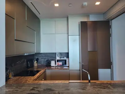 a kitchen with a sink and a microwave at Damac Heights - Blue Ocean Holiday Homes in Dubai
