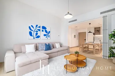 a living room with a couch and a table at LUX The Le Pont Sea View Suite in Dubai