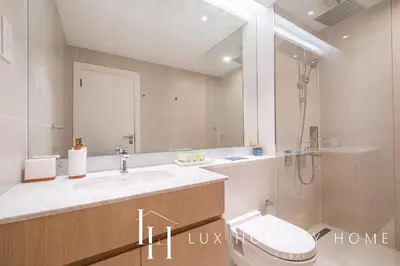 a bathroom with a sink and a toilet and a shower at LUX The Le Pont Sea View Suite in Dubai