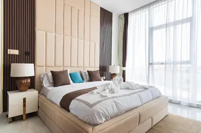 a bedroom with a large bed with a large window at Luxury 3Br Apts with Private Pool in Gemz by Simply Comfort in Dubai