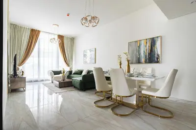 a living room with a table and a green couch at Luxury 3Br Apts with Private Pool in Gemz by Simply Comfort in Dubai