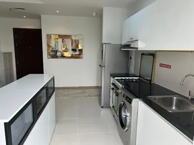 a kitchen with a washer and a sink and a stove at Binghatti Gateway 2BHK At Jaddaf By al Sarya Holiday Home in Dubai