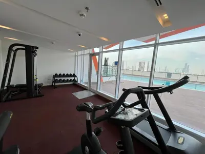 a gym with a view of a swimming pool at Binghatti Gateway 2BHK At Jaddaf By al Sarya Holiday Home in Dubai