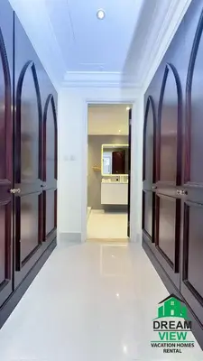 a dressing room with wooden doors and a hallway at Souk Al Bahar connected to Dubai Mall, Burj khalifa Partial View Dream View Holiday Home Rental in Dubai