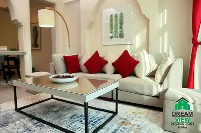 a living room with a couch and a coffee table at Souk Al Bahar connected to Dubai Mall, Burj khalifa Partial View Dream View Holiday Home Rental in Dubai