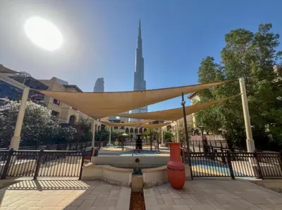a canopy over a fountain in a park at Souk Al Bahar connected to Dubai Mall, Burj khalifa Partial View Dream View Holiday Home Rental in Dubai