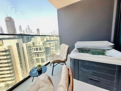 a balcony with a bed and a view of a city at Business Bay Studio Jacuzzi & Iconic View in Dubai