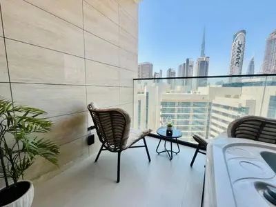 a balcony with two chairs and a table on a building at Business Bay Studio Jacuzzi & Iconic View in Dubai
