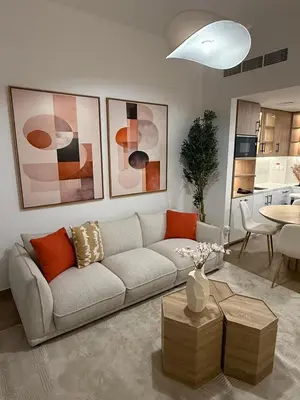 a living room with a couch and a table at Appartement moderne et élégant in Dubai