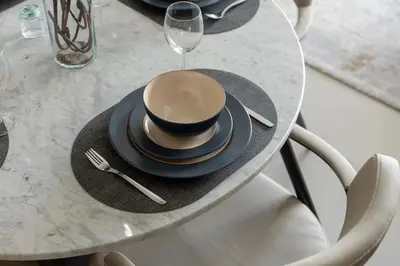 a table with a cup and a plate and a glass at Maison Privee - Serene Hideaway with Top Facilities in Creek Beach in Dubai