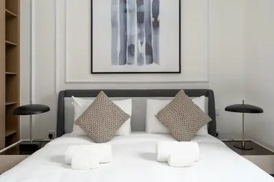 a bedroom with a white bed with two pillows at Maison Privee - Serene Hideaway with Top Facilities in Creek Beach in Dubai