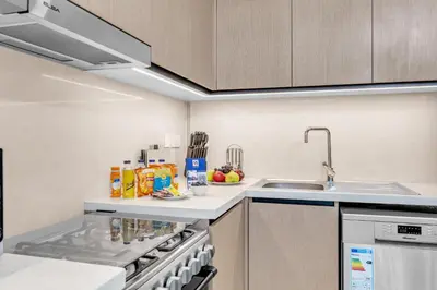 a kitchen with a sink and a counter top at Modern 2BR at Burj Crown Walk to Burj Khalifa by Vibel Stay in Dubai