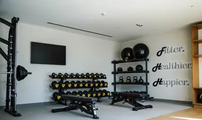 a gym with a wall filled with lots of wine bottles at Modern 2BR at Burj Crown Walk to Burj Khalifa by Vibel Stay in Dubai