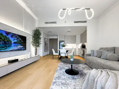 a living room with a couch and a table at Chic Dubai Apartment Creek View Peaceful Vibes in Dubai