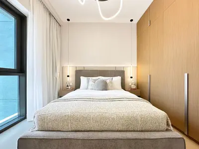 a bedroom with a large bed and a large window at Chic Dubai Apartment Creek View Peaceful Vibes in Dubai