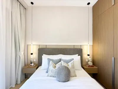 a bedroom with a large bed with white sheets and pillows at Chic Dubai Apartment Creek View Peaceful Vibes in Dubai