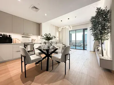 a kitchen and dining room with a table and chairs at Chic Dubai Apartment Creek View Peaceful Vibes in Dubai