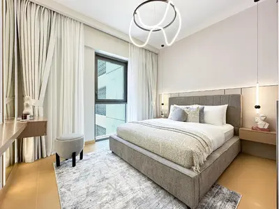 a bedroom with a large bed and a large window at Chic Dubai Apartment Creek View Peaceful Vibes in Dubai